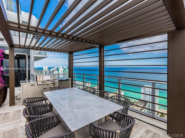 view of terrace featuring an outdoor kitchen and a pergola