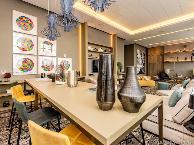 kitchen with a kitchen island, a kitchen bar, and a tray ceiling