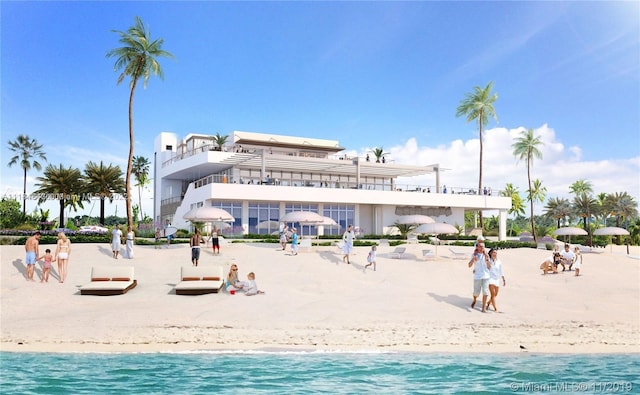 exterior space with a water view and a view of the beach