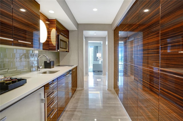 kitchen featuring sink, light tile floors, stainless steel microwave, dishwashing machine, and backsplash