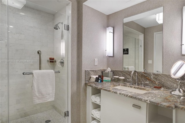 bathroom with vanity and a shower with door