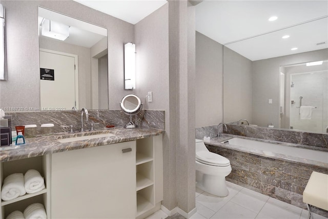 bathroom with toilet, tile floors, a relaxing tiled bath, and vanity