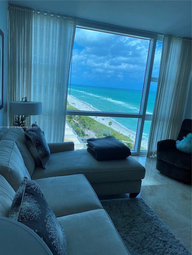 living room with expansive windows and a water view