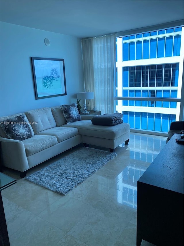 living room featuring a wall of windows and tile flooring