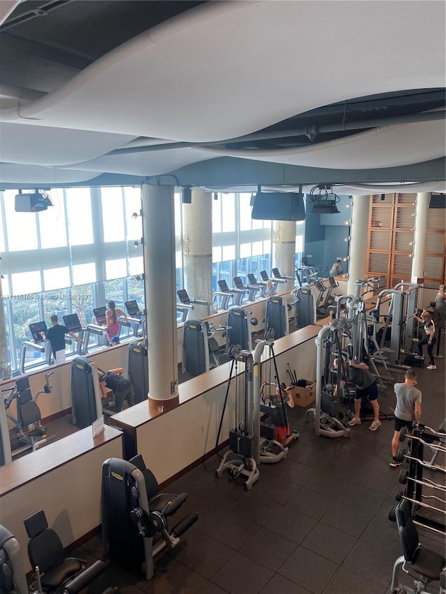 workout area with plenty of natural light and dark tile flooring