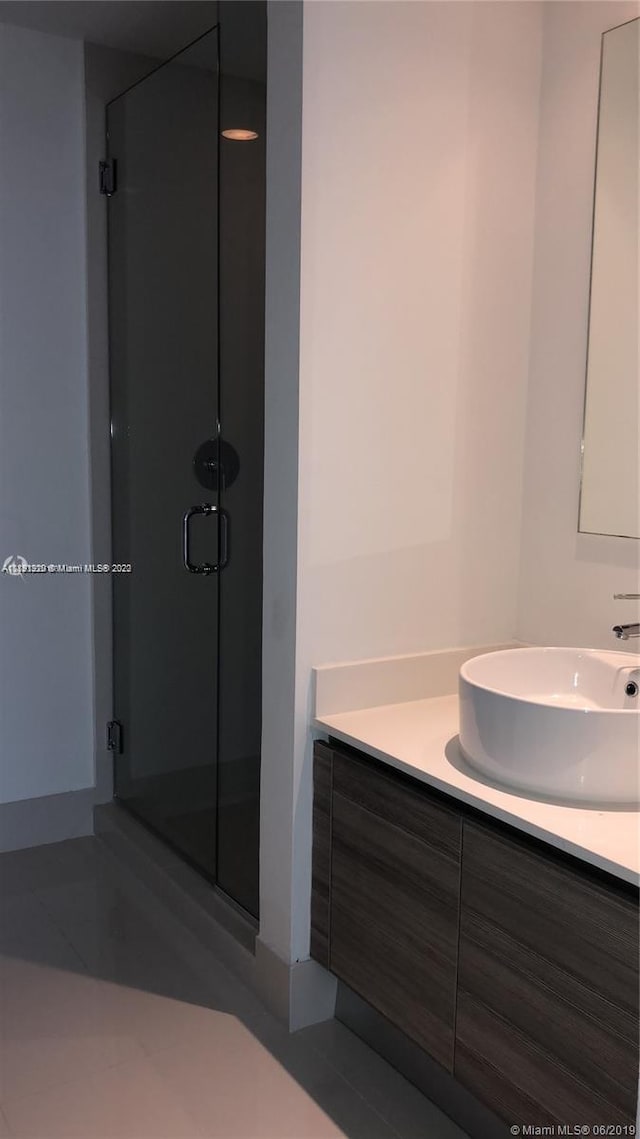 bathroom with an enclosed shower and vanity