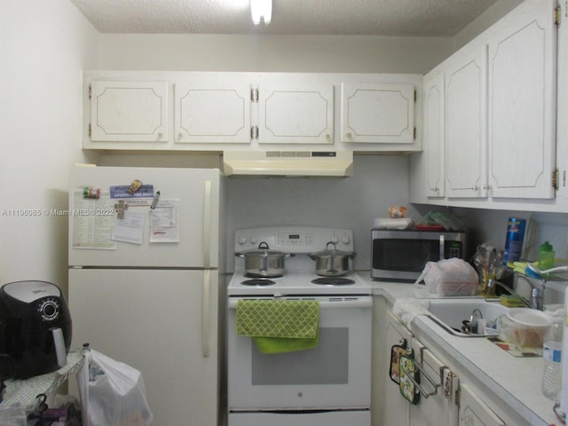 kitchen featuring white appliances, white cabinetry, a textured ceiling, and sink