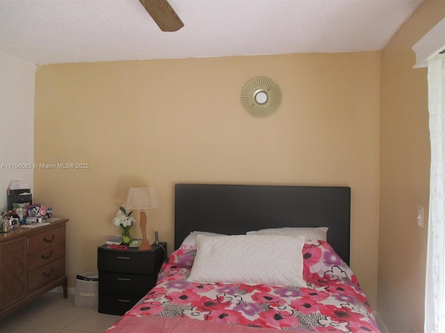 tiled bedroom featuring ceiling fan