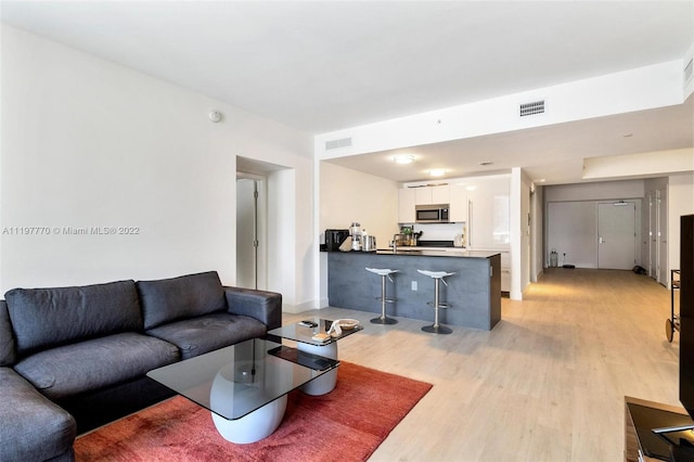 living room with light hardwood / wood-style flooring