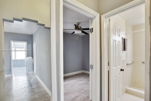 hallway with light hardwood / wood-style flooring