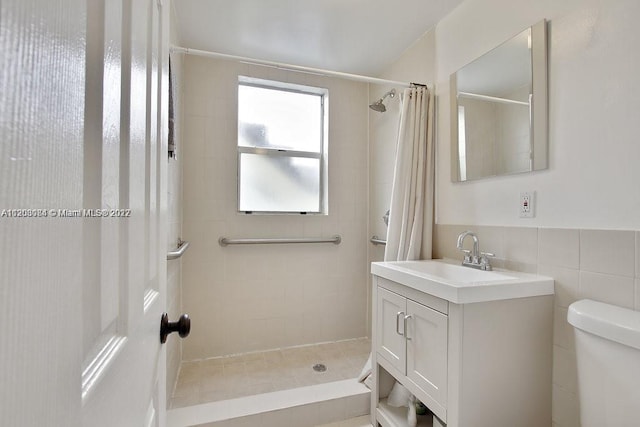 bathroom featuring tile walls, toilet, vanity, and a shower with shower curtain