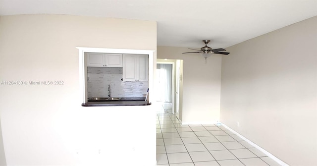 kitchen featuring ceiling fan, light tile flooring, sink, tasteful backsplash, and gray cabinets