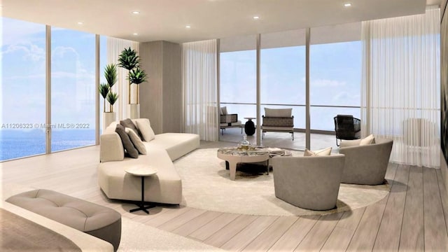 living room with plenty of natural light, expansive windows, light hardwood / wood-style flooring, and a water view