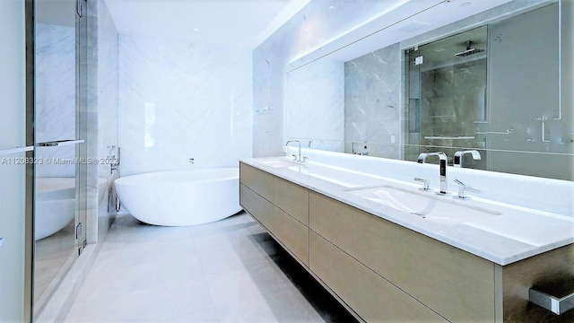 bathroom featuring tile walls, dual bowl vanity, and tile flooring