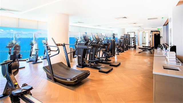 exercise room featuring light parquet floors