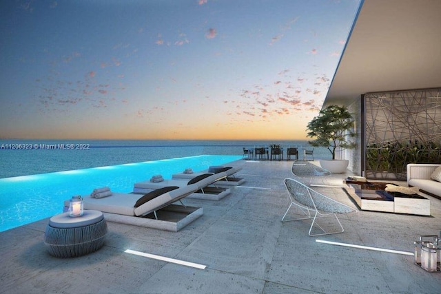 pool at dusk with a water view