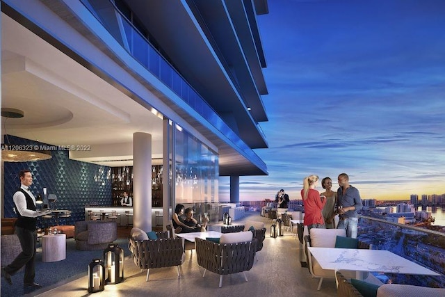 patio terrace at dusk with a balcony and outdoor lounge area