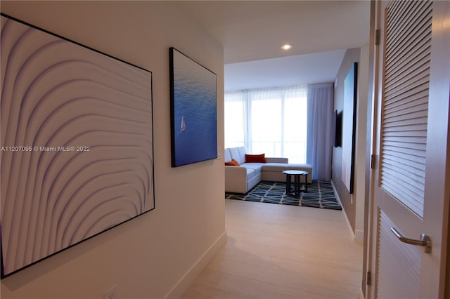 hall with light hardwood / wood-style floors