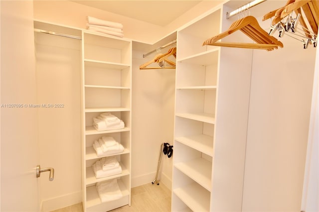 spacious closet featuring light tile flooring