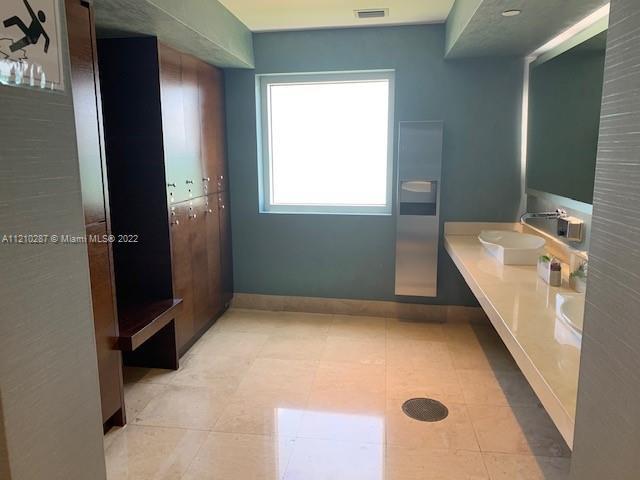 bathroom with tile floors and sink