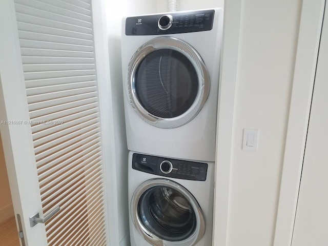 laundry area with stacked washer and clothes dryer