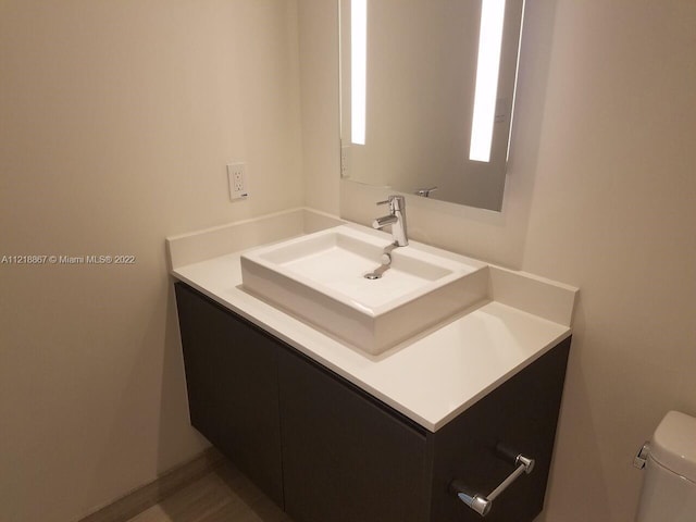 bathroom featuring toilet and vanity