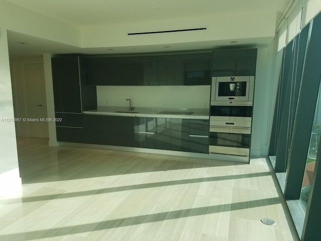 kitchen featuring black electric cooktop and sink