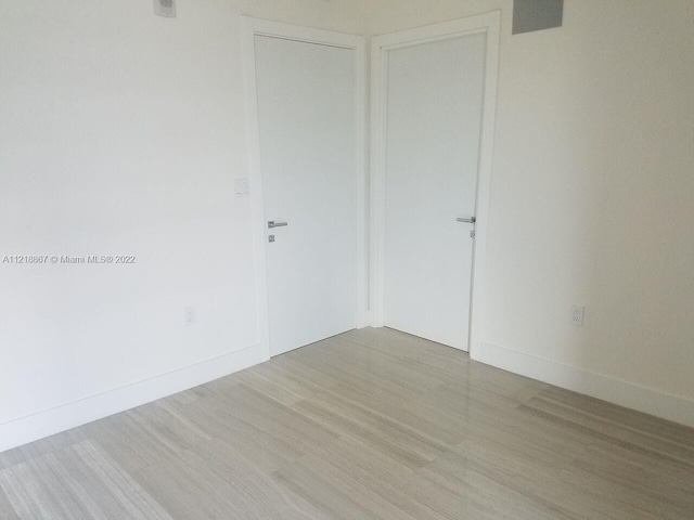 spare room featuring light hardwood / wood-style floors