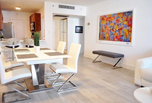 dining room with light wood-type flooring