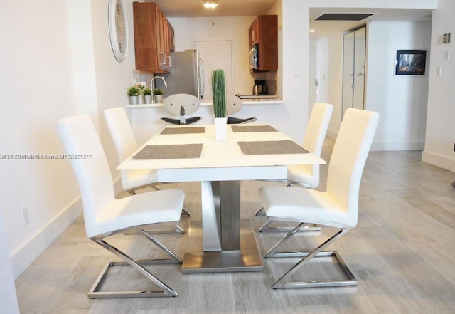 dining area featuring light wood-type flooring