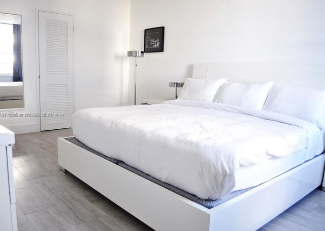 bedroom featuring light hardwood / wood-style floors and a closet