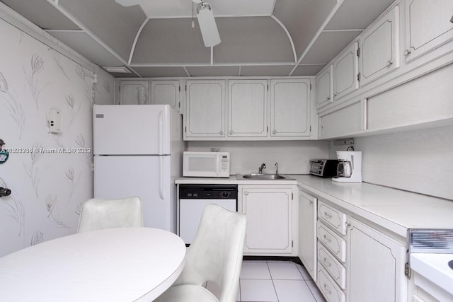 kitchen with white appliances, ceiling fan, sink, light tile floors, and white cabinets