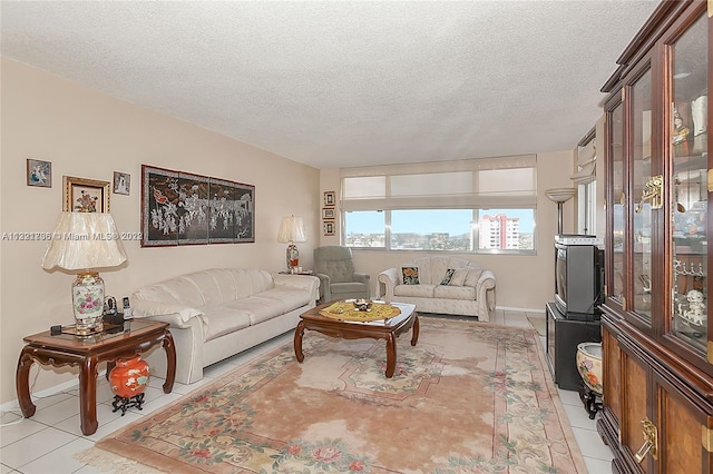 tiled living room featuring a textured ceiling