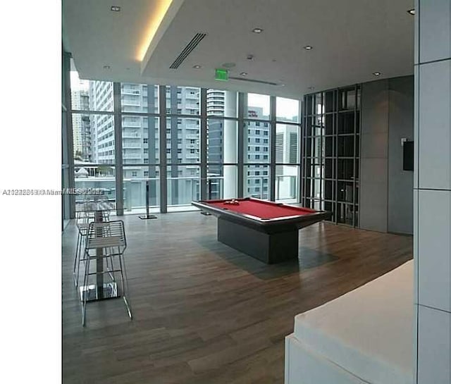 playroom featuring floor to ceiling windows, hardwood / wood-style floors, and billiards