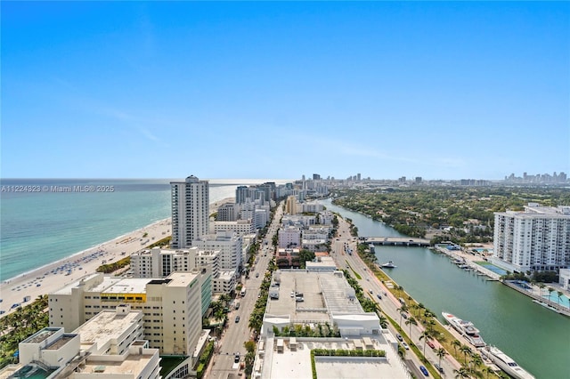 aerial view with a water view and a view of the beach