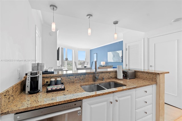 kitchen featuring white cabinetry, sink, light stone counters, stainless steel dishwasher, and decorative light fixtures