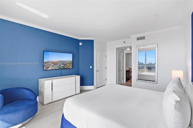 bedroom with ornamental molding and light hardwood / wood-style flooring