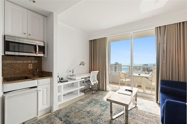 living room with crown molding and a water view