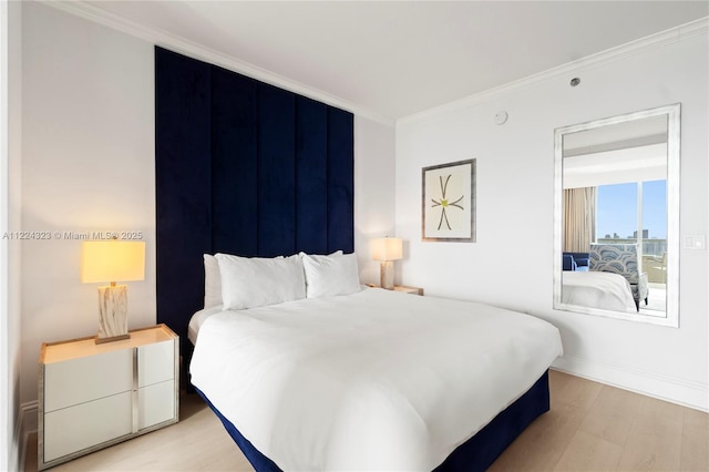 bedroom featuring ornamental molding and light wood-type flooring