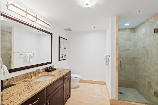 bathroom featuring vanity, toilet, and walk in shower