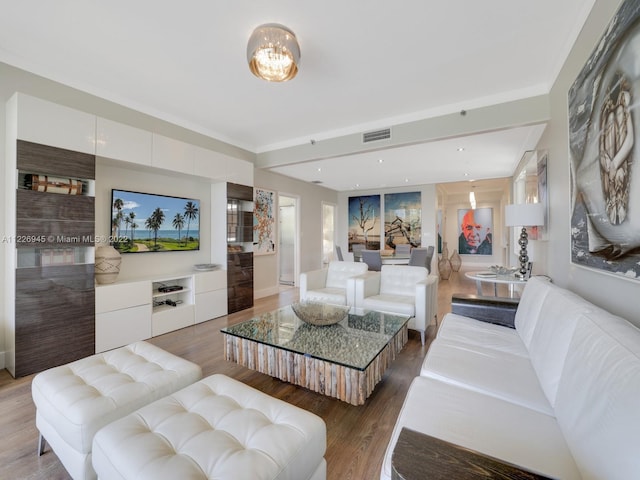 living room featuring a notable chandelier and light hardwood / wood-style flooring