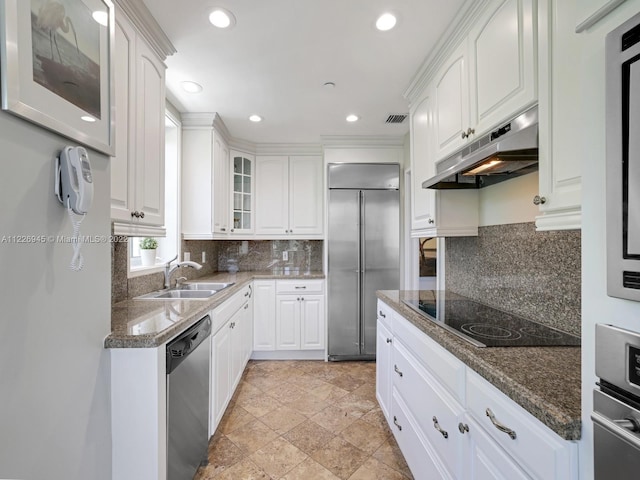 kitchen with backsplash, stainless steel appliances, light tile flooring, and white cabinets