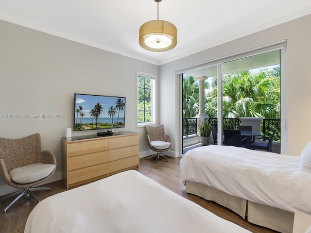 bedroom with dark hardwood / wood-style flooring, access to exterior, and ornamental molding