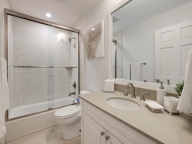 full bathroom featuring toilet, tile floors, large vanity, and enclosed tub / shower combo