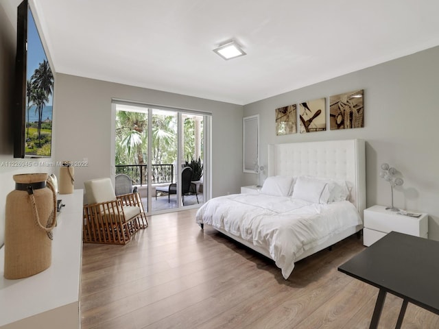 bedroom featuring light hardwood / wood-style floors and access to outside