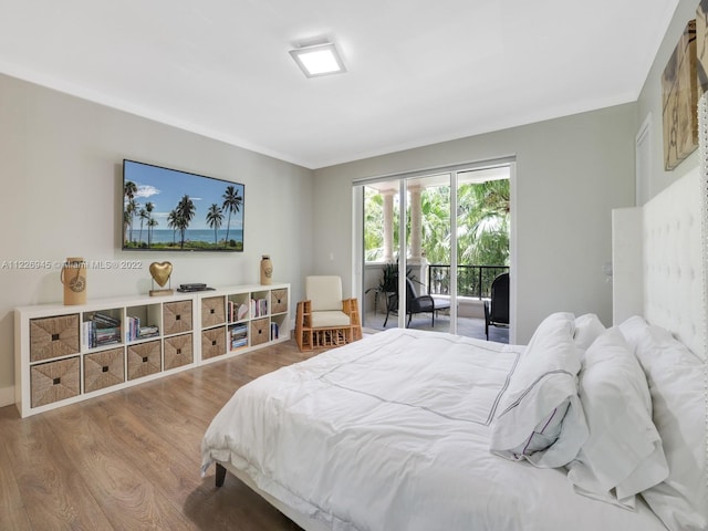 bedroom with access to outside, crown molding, and wood-type flooring