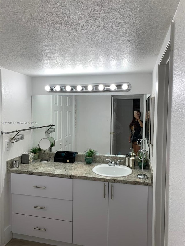 3401 N Country Club Dr Unit 406, Aventura, FL 33180 - bathroom with vanity and a textured ceiling