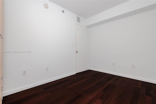 unfurnished room with wood-type flooring