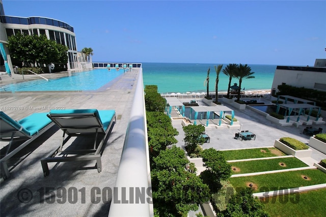 view of swimming pool featuring a water view and a patio area