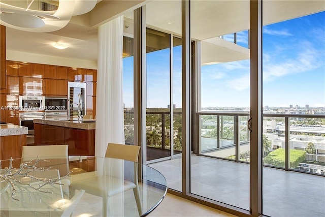 unfurnished dining area featuring expansive windows and sink